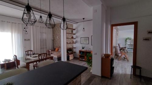 a living room with a table and a dining room at Il Ginepro del Campidano in Nuraminis