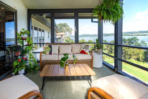 a screened in porch with a couch and a table at Hudson House in Newburgh