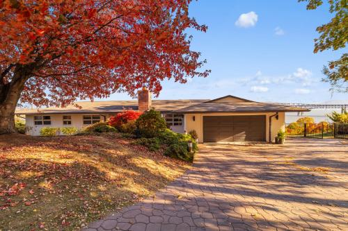 a house with a tree and a driveway at Hudson House in Newburgh