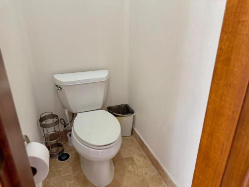a bathroom with a white toilet in a room at Depa Frente a la Playa con Vistas en EDM in Mazatlán