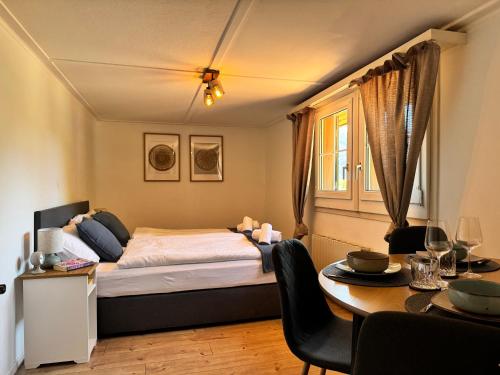 a bedroom with a bed and a dining table at River 4-Kissed Retreat with Iconic Jungfraujoch View in Interlaken