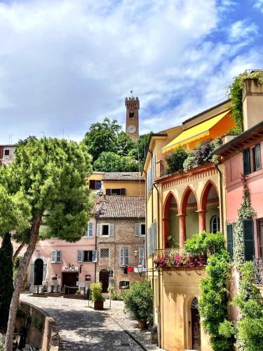 a street in a town with a clock tower at al Centro di Santarcangelo in Santarcangelo di Romagna