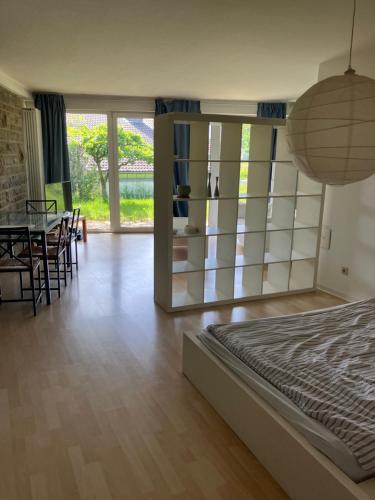 a bedroom with a bed and a table and chairs at Taunus Wohnen und Arbeiten mit eigener Terrasse in Friedrichsdorf
