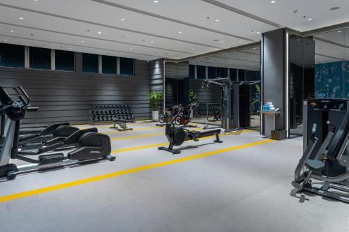 a gym with treadmills and cardio equipment in a building at Hotel Indigo Suzhou Jinji Lake by IHG in Suzhou