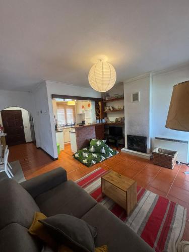 a living room with a couch and a fireplace at A Casa de São Pedro de Moel in São Pedro de Moel
