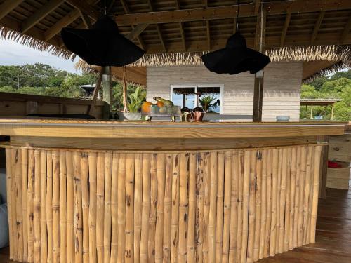 a bar with a wooden fence in front of a house at CoralBay Bungalows Solarte in Solarte
