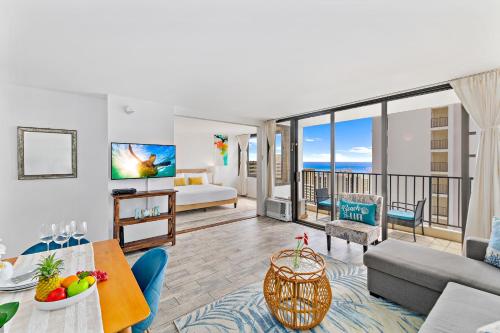 a living room with a couch and a bed at 1BR with Great Ocean Views, 1 Block to Waikiki Beach in Honolulu