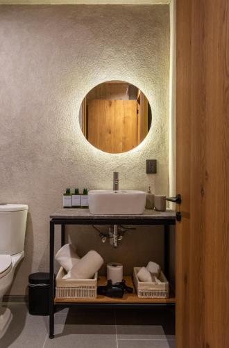 a bathroom with a sink and a mirror at Departamentos y Suites Índigo in Querétaro