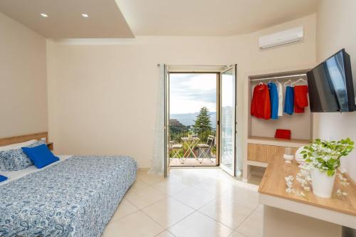 a bedroom with a bed and a sliding glass door at Vittoria Luxury Suite in Vico Equense