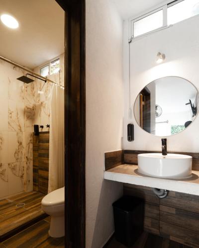 a bathroom with a sink and a mirror at Hotel Posada Bugambilias in San Luis Potosí