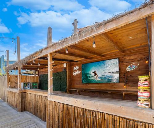 a wooden building with a large tv on the side at Good Life Resorts in San Diego
