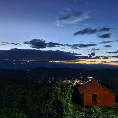 a barn sitting on top of a hill at night at Cabaña El Retiro en Guaduas in Guaduas