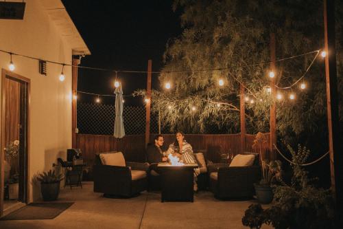 two women sitting on a patio at night at Oasis 444 in San Marcos