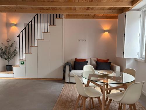 a living room with a table and a couch at Casas do Mercado, 3 in Montemor-o-Novo