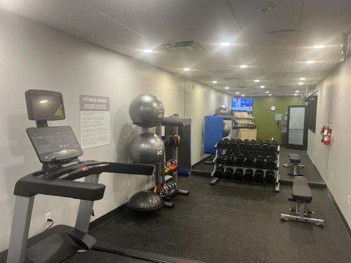 a room with a gym with a treadmill and weights at Spark by Hilton Phoenix East Mesa in Mesa