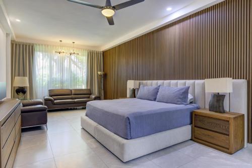 a bedroom with a bed and a living room at El Tigre, Green Bay I Shared Pool in Nuevo Vallarta 