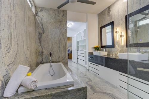 a bathroom with a tub and a sink at El Tigre, Green Bay I Shared Pool in Nuevo Vallarta 