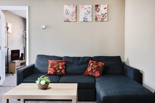 a blue couch in a living room with a coffee table at RELAXED CENTRAL HOUSE LOCATED IN WEST READING CLOSE TO TOWN CENTRE with FREE DRIVE WAY PARKING, WI FI & NETFLIX BY AI ESTATE GROUP in Reading