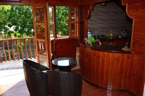 a porch with chairs and a bar on a deck at Belle Amie Self Catering in La Digue