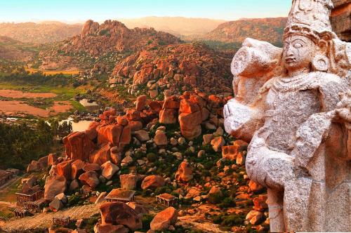 a stone statue on top of a mountain at Malligi,Hampi in Hospet