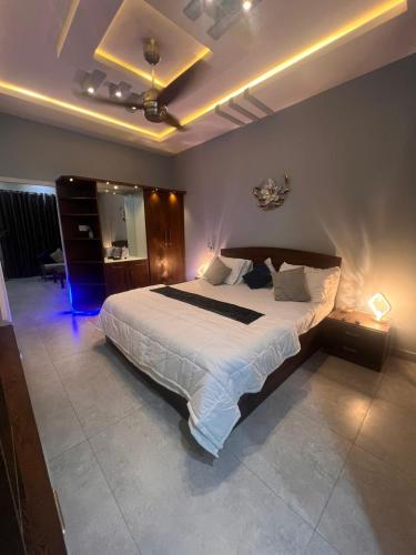a bedroom with a large bed with lights on it at Private in Dargai