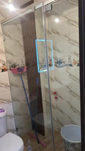 a bathroom with a glass shower with a toilet at Saidia in Saidia 