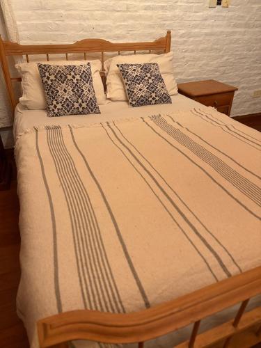 a bed with two pillows on top of it at El retoño in San Antonio de Areco