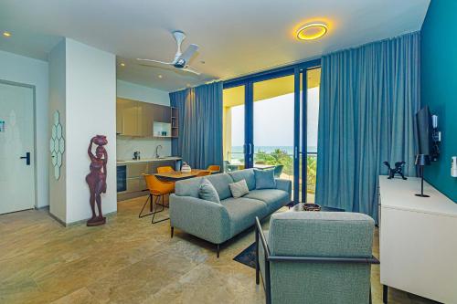 a living room with a couch and a table at The Edge in Bijilo