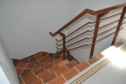 a set of stairs with a wooden rail at Casa Finca Salamandra in Santa Fe de Antioquia