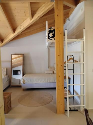 a bedroom with bunk beds in a room with wooden ceilings at Amaryllis House in Parga