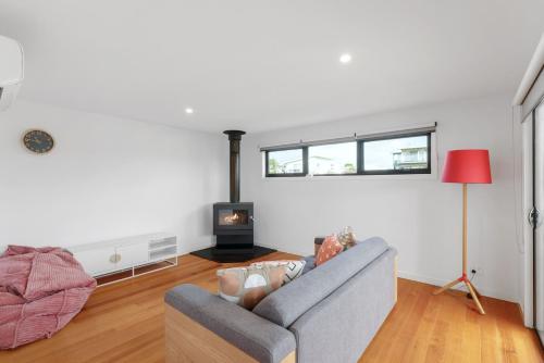 a living room with a couch and a fireplace at Surf Mist at Surf Beach in Surf Beach