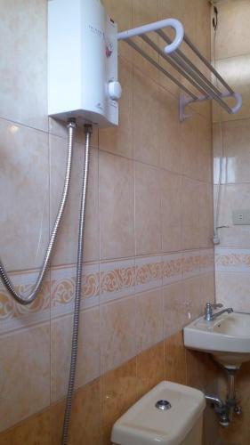 a bathroom with a toilet and a sink at Ricardo Valley Inn in Coron