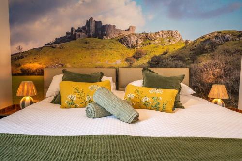 a bedroom with a bed with a painting of a castle at Rosemary Lodge 2BR with Hot Tub and Sauna near Black Mountain in Garnant
