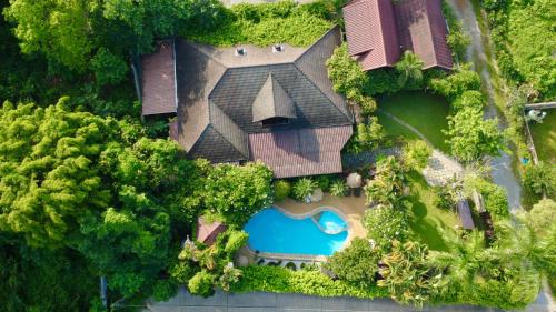 an overhead view of a house with a swimming pool at Homestay Chiangrai in Chiang Rai