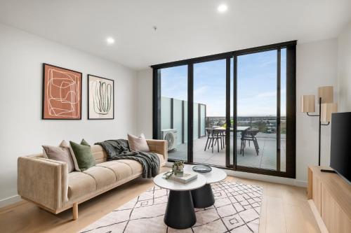a living room with a couch and a table at Hobson Apartments by Urban Rest in Newport