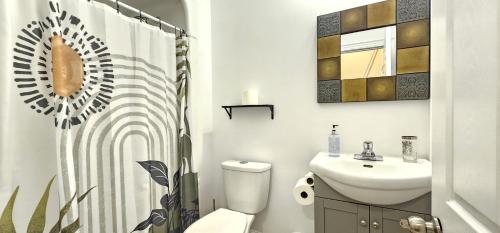 a bathroom with a white toilet and a sink at Perfect Location! Quiet-Spacious-2 Bed-2 Bath in Windsor