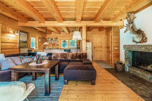 a living room with a table and a fireplace at Chalupa u Golisov in Zákopčie