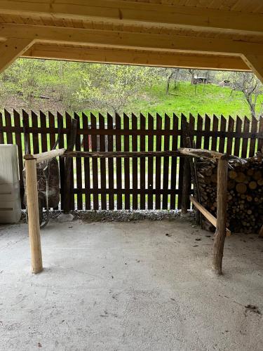 a wooden bench in front of a wooden fence at Chalupa u Golisov in Zákopčie