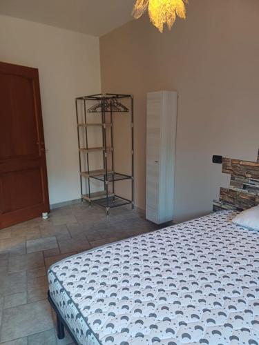 a bedroom with a bed and a shelf in a room at Nardy's house in Sorso