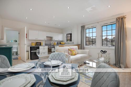 a living room with a couch and a table at George Street Apartment - Grampian Lettings in Aberdeen