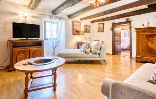 a living room with a tv and a table at Stunning Home In Plazac With Wifi in Plazac