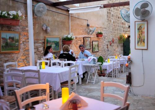 
a restaurant with tables and chairs and people at Stou Kir Yianni in Omodos
