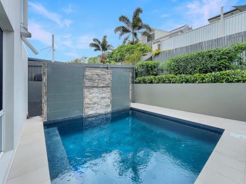 a swimming pool in the backyard of a house at Relaxed Luxury for Families by the Beach in Buddina