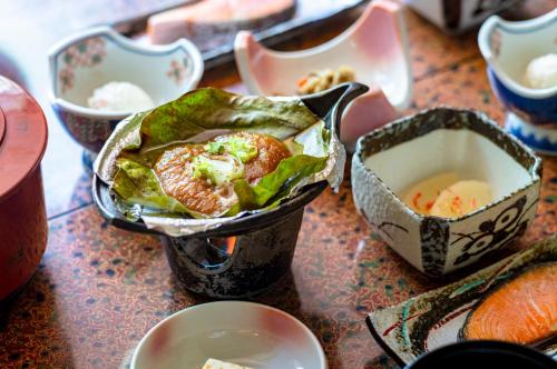 a table topped with dishes of food on a table at 焼乃湯 in Takayama