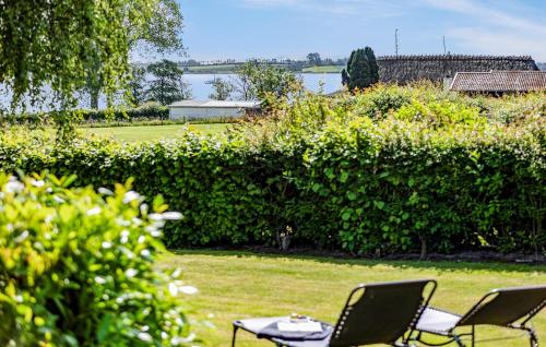 two chairs and a table in a yard at Holiday Home Lundvej Sønderborg Xii in Vollerup