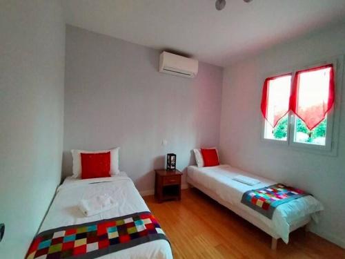 a bedroom with two beds and a window at Modern Villa with Pool in Montauroux France in Montauroux