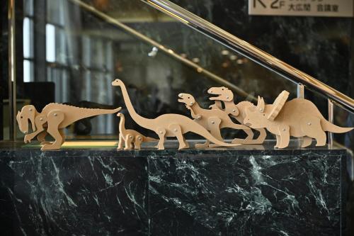 a group of dinosaur figurines sitting on top of a counter at Kyukamura Echizen-Mikuni in Sakai