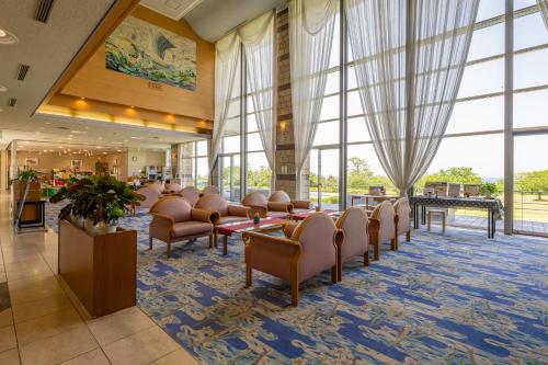 a waiting area in a hospital with chairs and windows at Kyukamura Echizen-Mikuni in Sakai