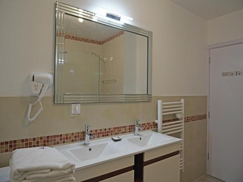 a bathroom with a sink and a mirror at Modern Villa with Pool in Montauroux France in Montauroux