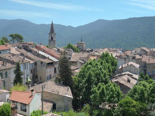 a group of buildings in a town with a church at Modern Villa with Pool in Montauroux France in Montauroux